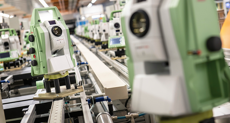 Leica Geosystems Total Stations lined up on a conveyor belt 